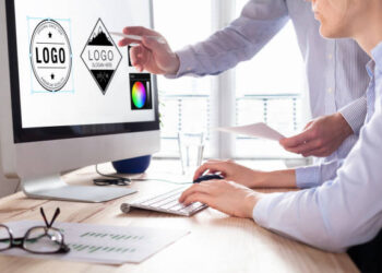 Designer team sketching a logo in digital design studio on computer, creative graphic drawing skills for marketing and branding (own design elements on the computer screen)